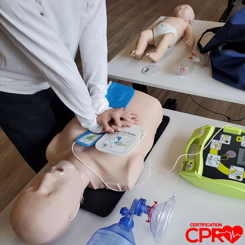CPR training with mannequin and AED for certification in Arlington.
