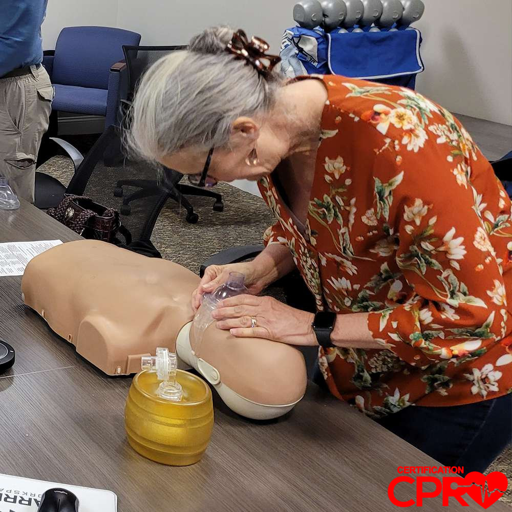 CPR training session with adult mannequin in Arlington.