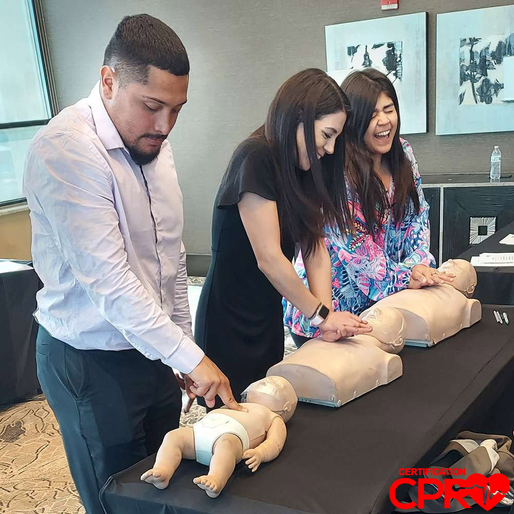 CPR training class in Arlington with students practicing on mannequins.